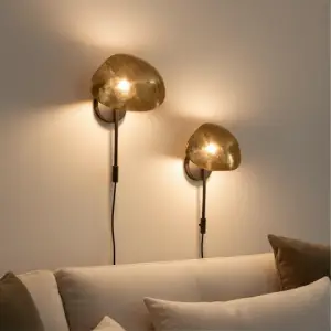 Stylish wall sconces providing ambient light, a space-saving lighting solution that enhances the atmosphere in small living rooms.