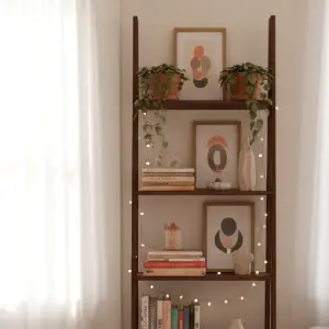 Close-up of a slim vertical bookshelf, showcasing organized books, plants, and string lights, a perfect space saving bookcase.